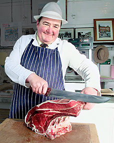 A butcher butchering.